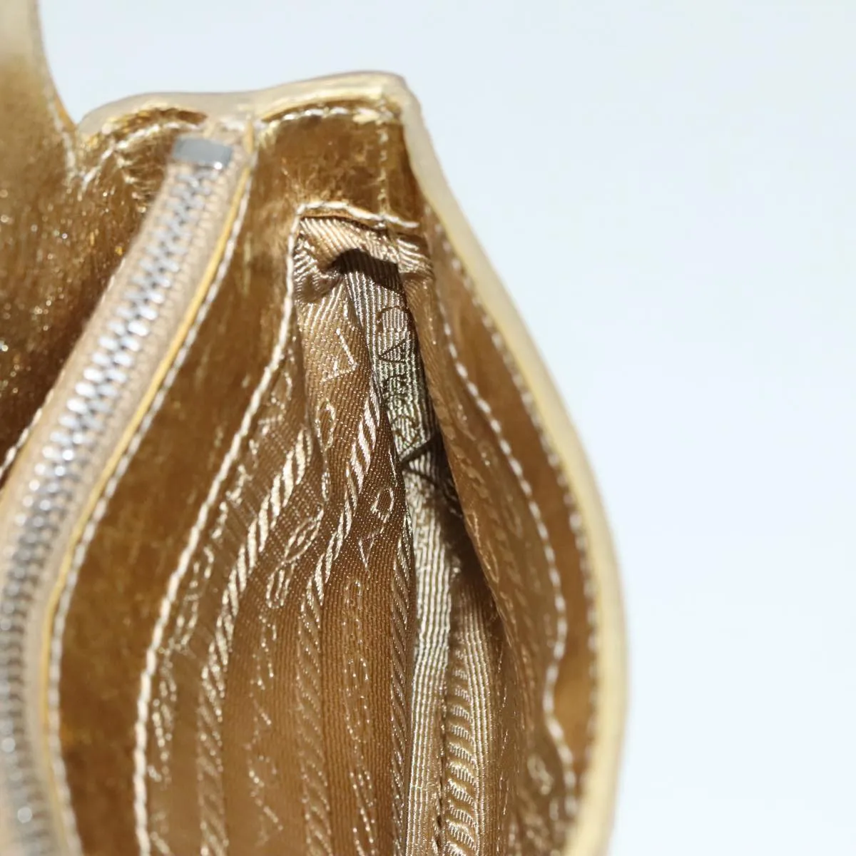 Prada -- Gold Leather Accessories